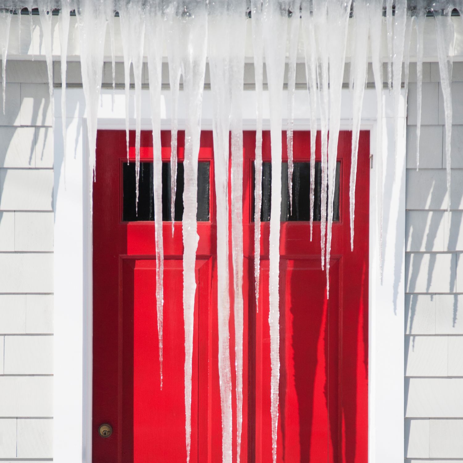 Icicles covering front of house in winter