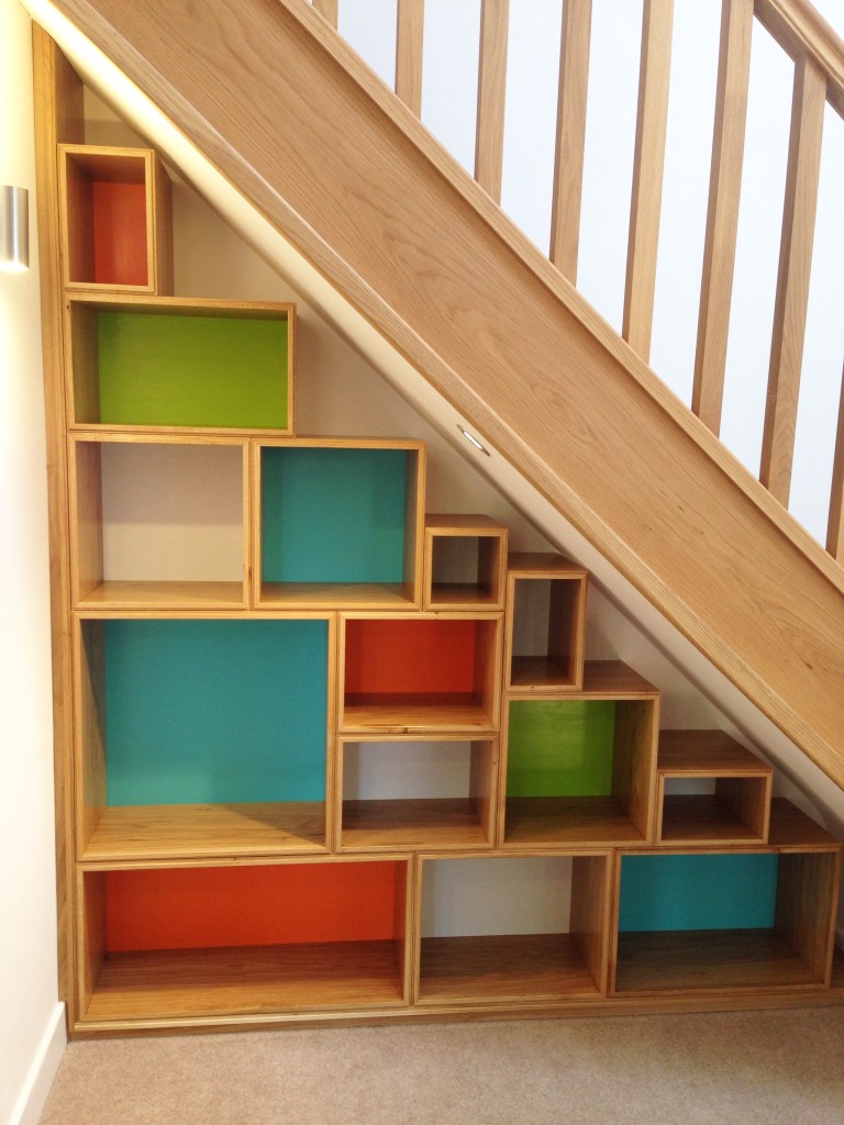 Colorful storage boxes under stairs