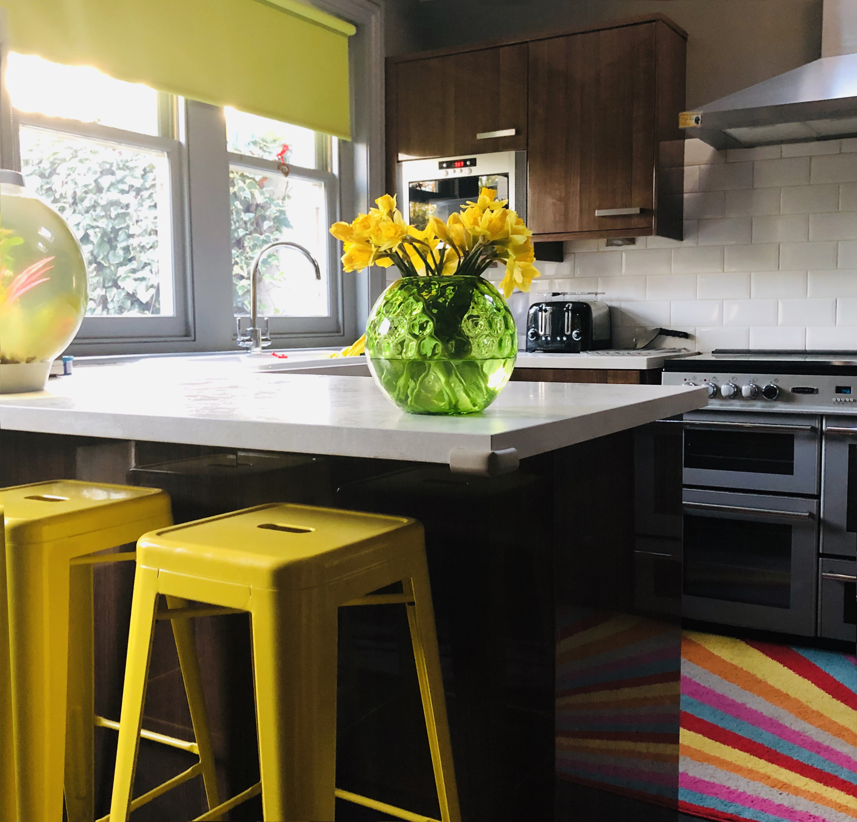 https://www.houselogic.com/wp-content/uploads/2019/05/kitchen-countertops-yellow-accents.jpg