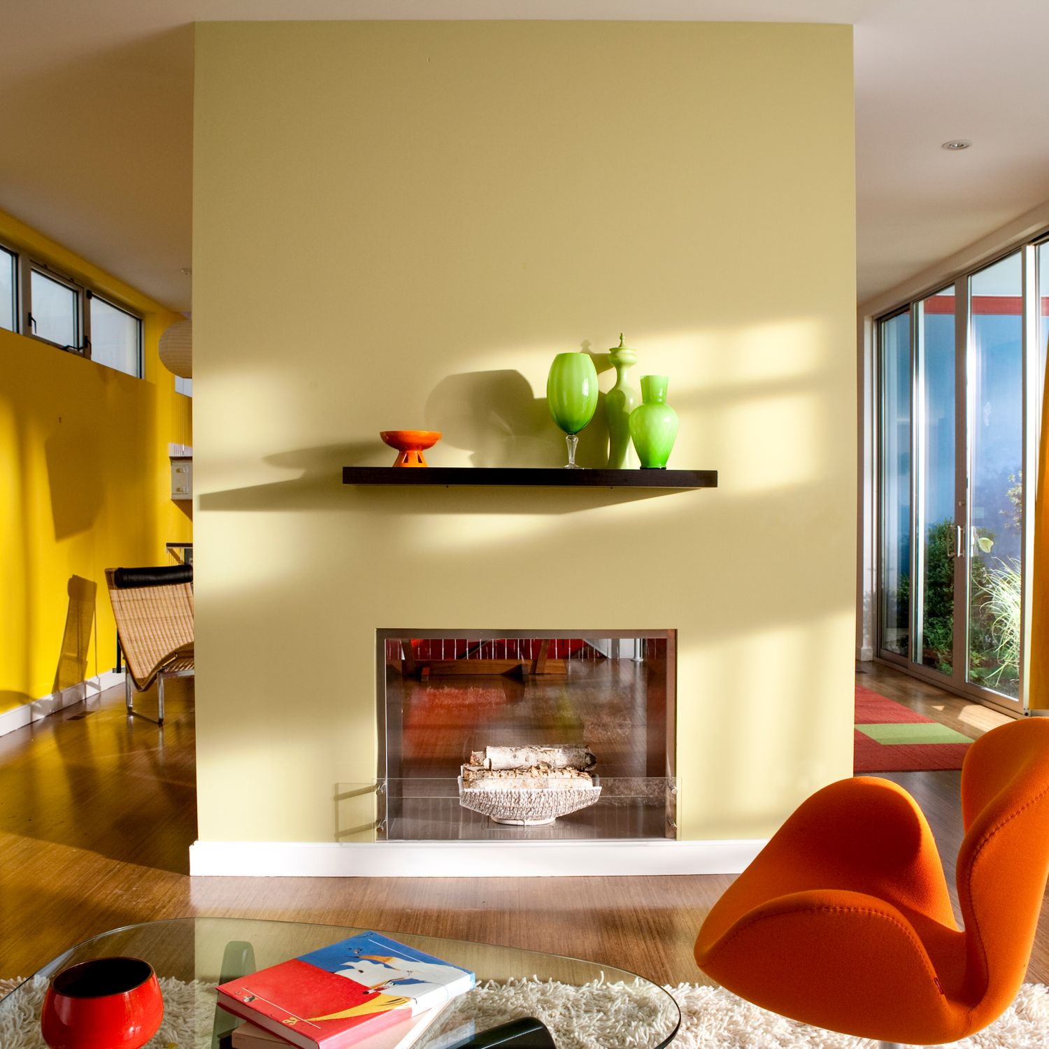 how much does it cost to paint your house image of a mid century modern home painted with bright and warm hues of yellow and orange with green accents and a dual sided fireplace as a focal point