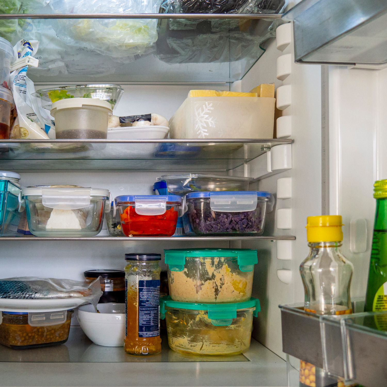 organized refrigerator open fridge with leftover food in glass containers other groceries