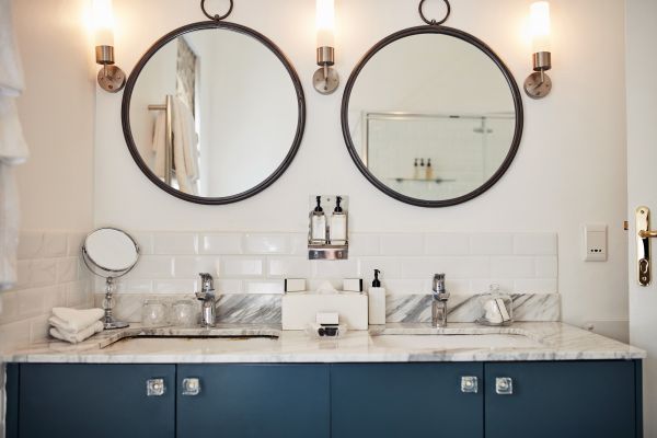 A bathroom with two mirrors and two sinks shows what a bathroom remodel could look like.