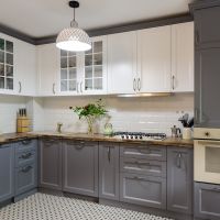 A modern, luxury remodeled kitchen with grey and white cabinets.