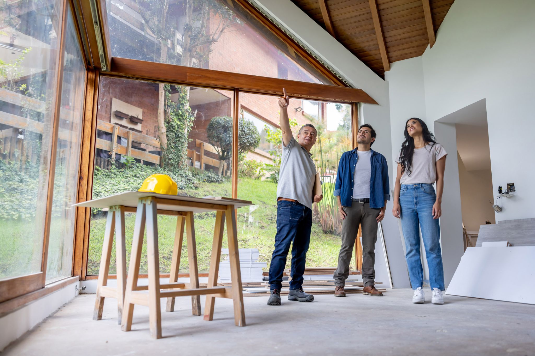 A remodeling contractor talking to clients about renovating and remodeling their house.