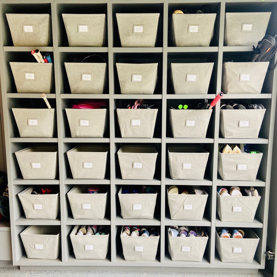 An after shot of organized shelves in a garage filled with sports equipment.