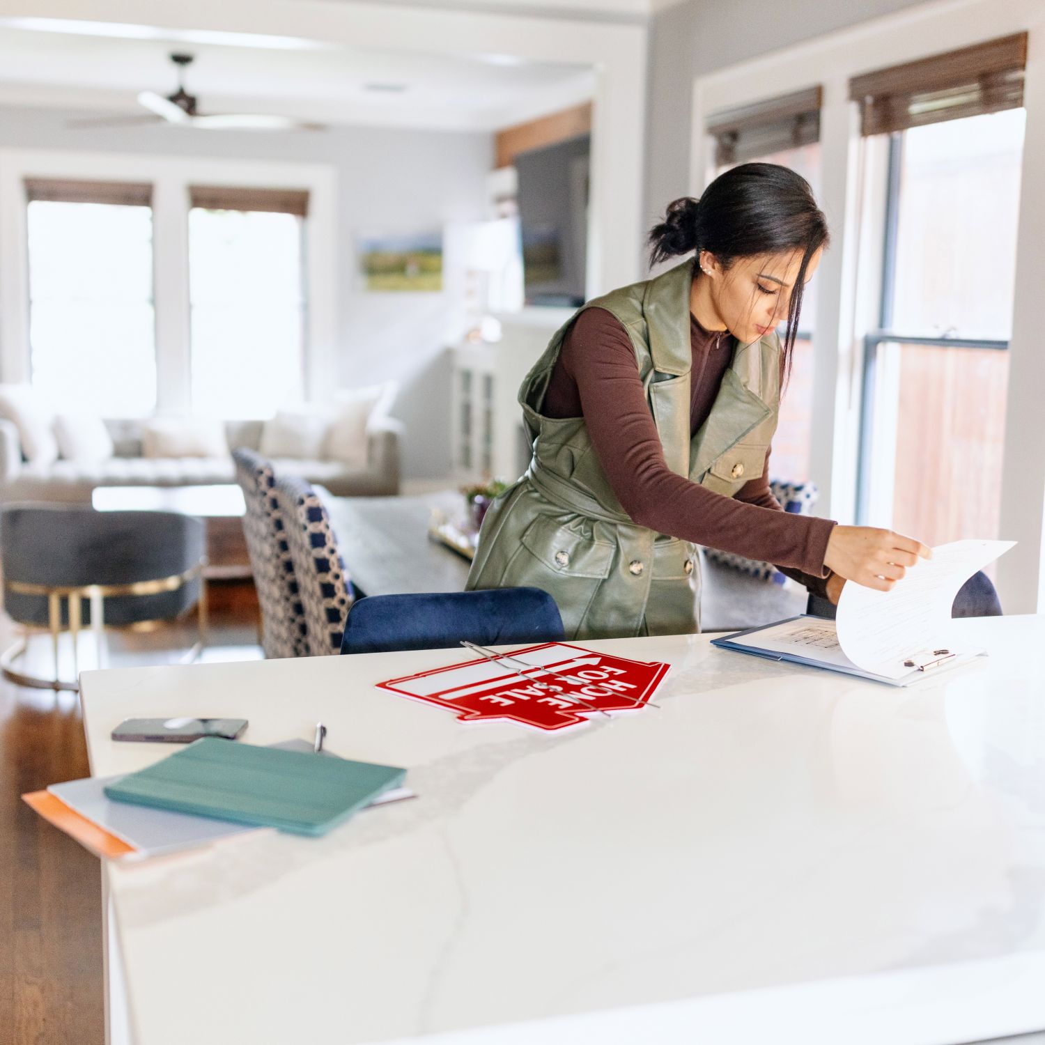 Real estate agent preparing for an open house for her clients.