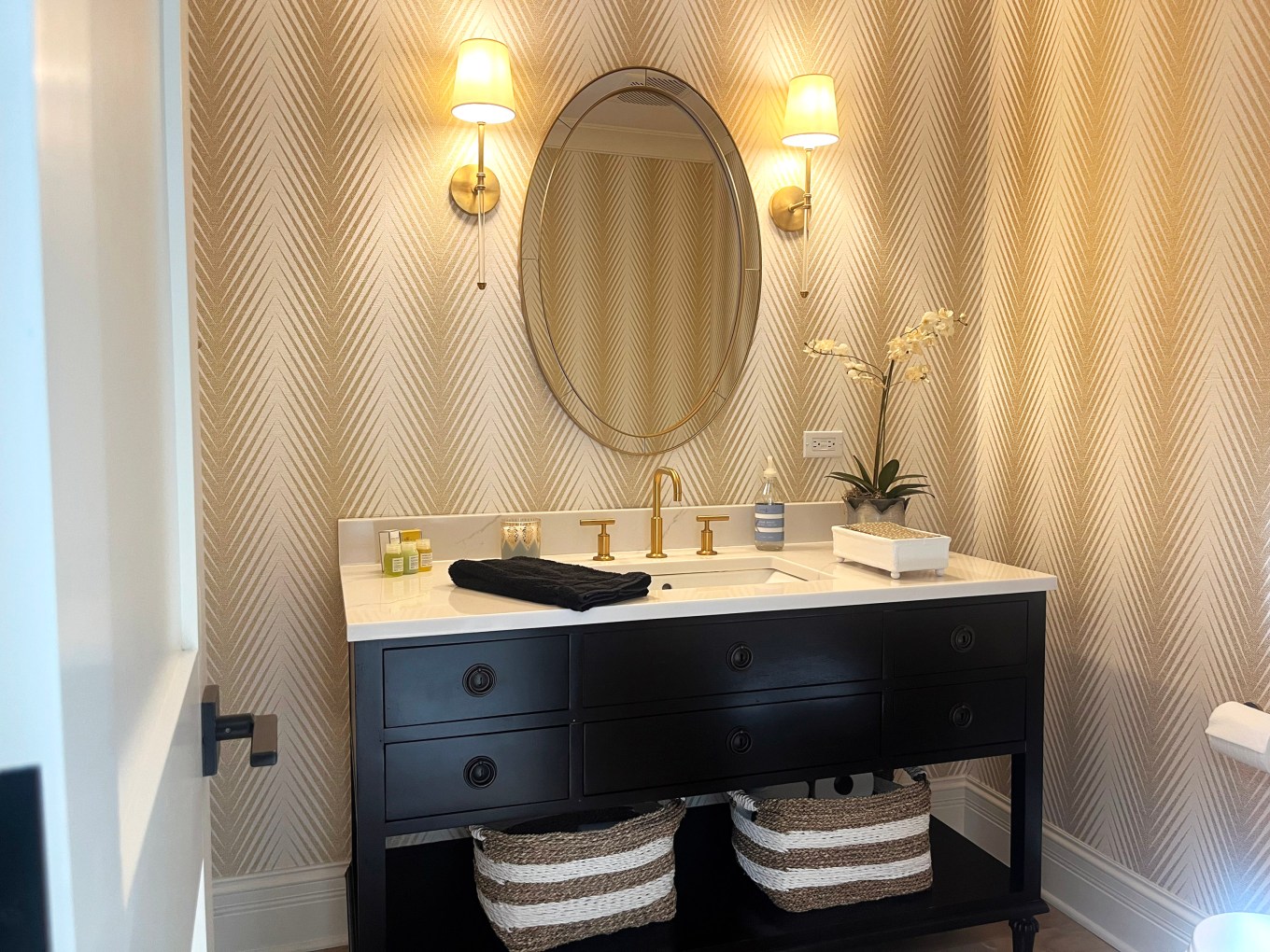 A view of a guest bathroom with a beautiful counter top and drawers.