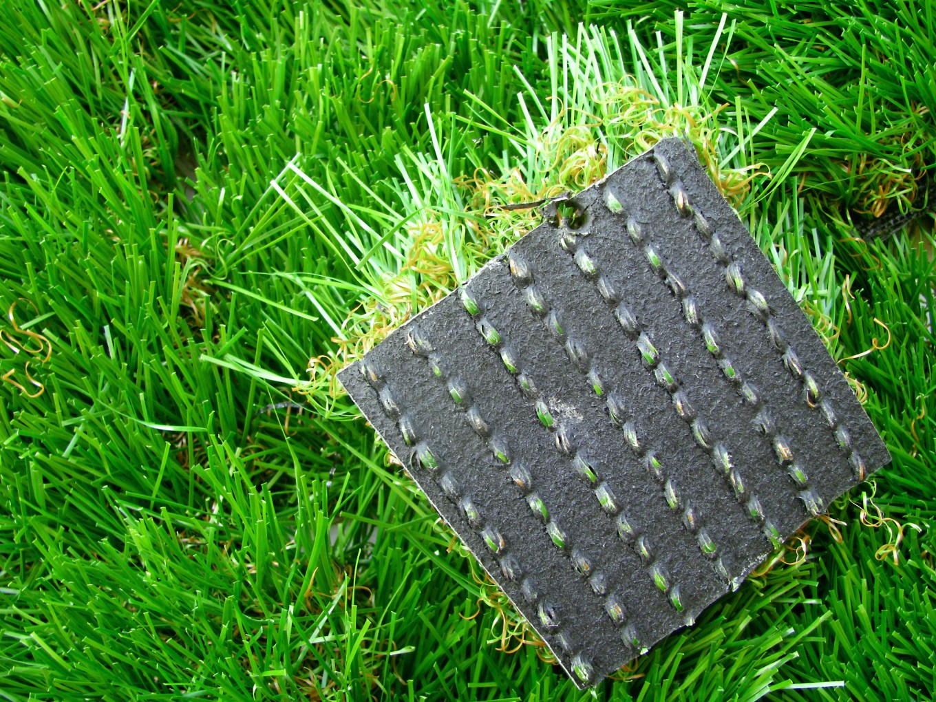 Are artificial grass costs worth it? This photo shows artificial grass including the underside or base.