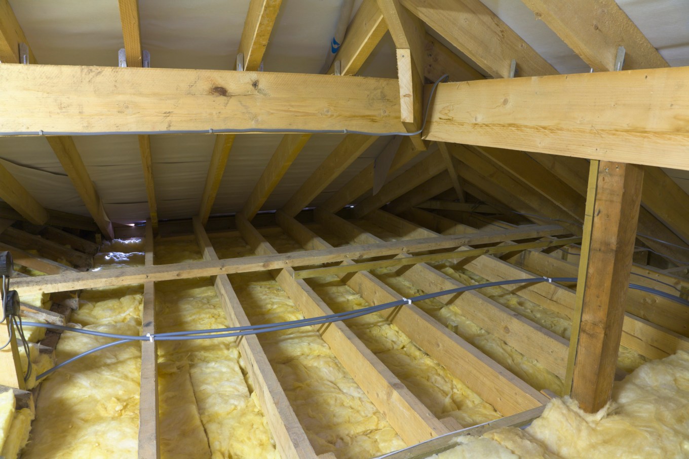 Insulation in the floor of an attic for weatherproofing.