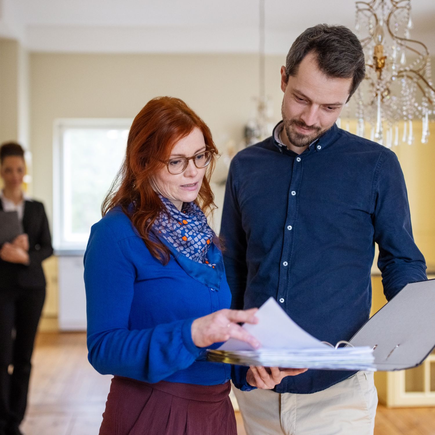 A REALTOR and a client looking at a document together for a Real Estate transaction.