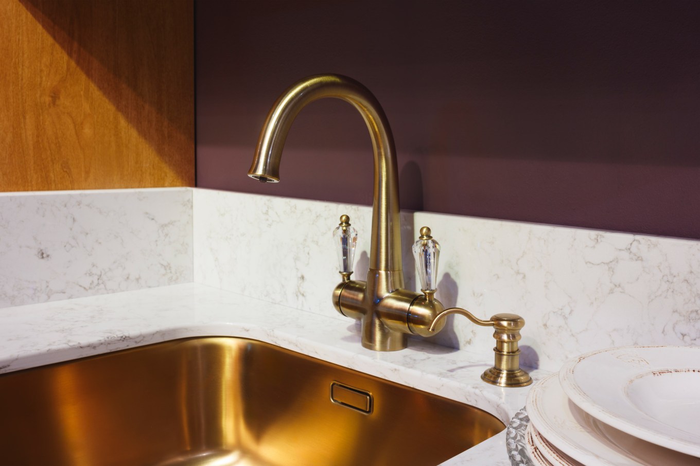 A beautiful bathroom counter with a brass sink as an example of a home trend for 2025.