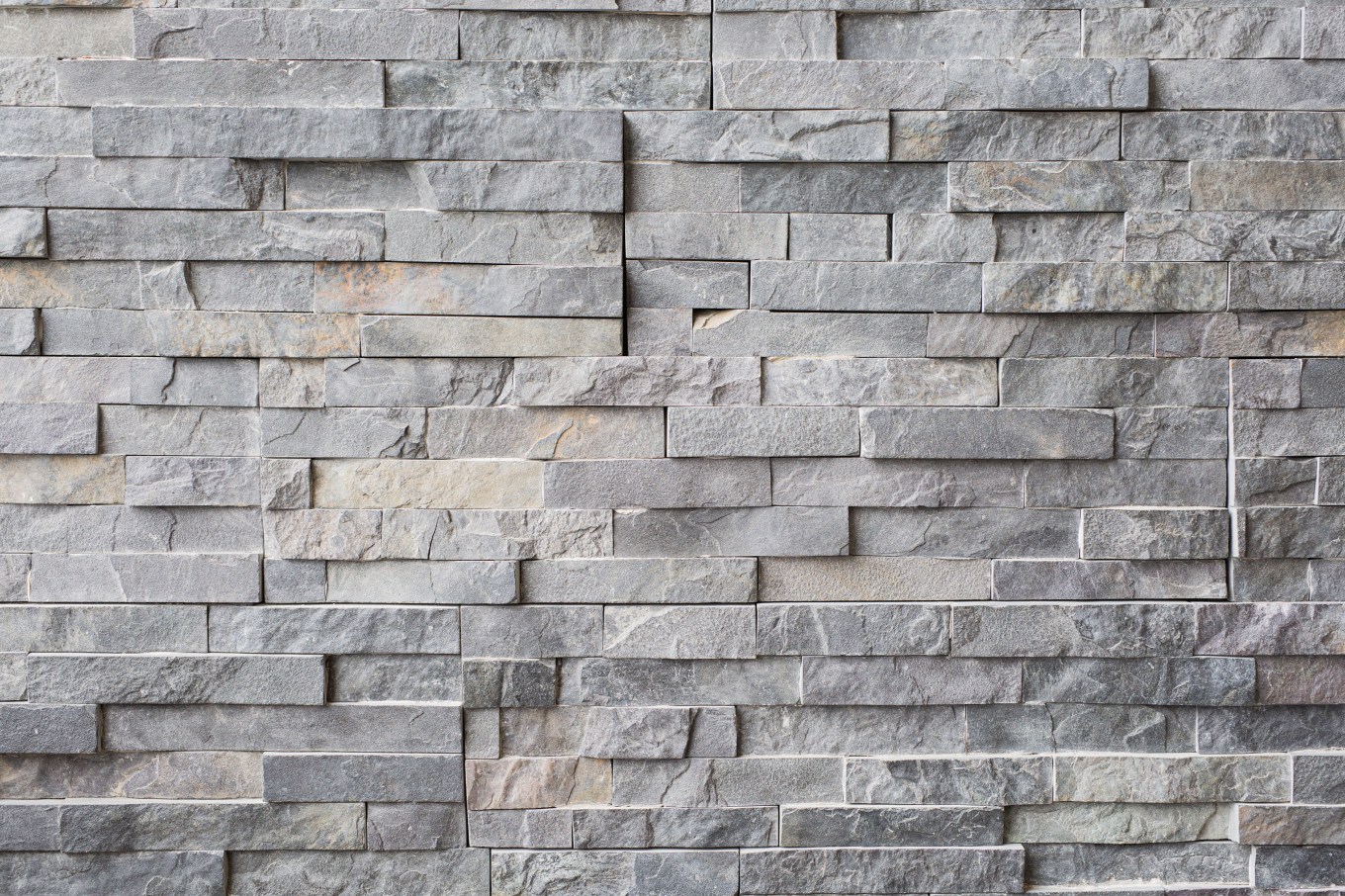 Close up of the texture of stone veneer siding on a house.