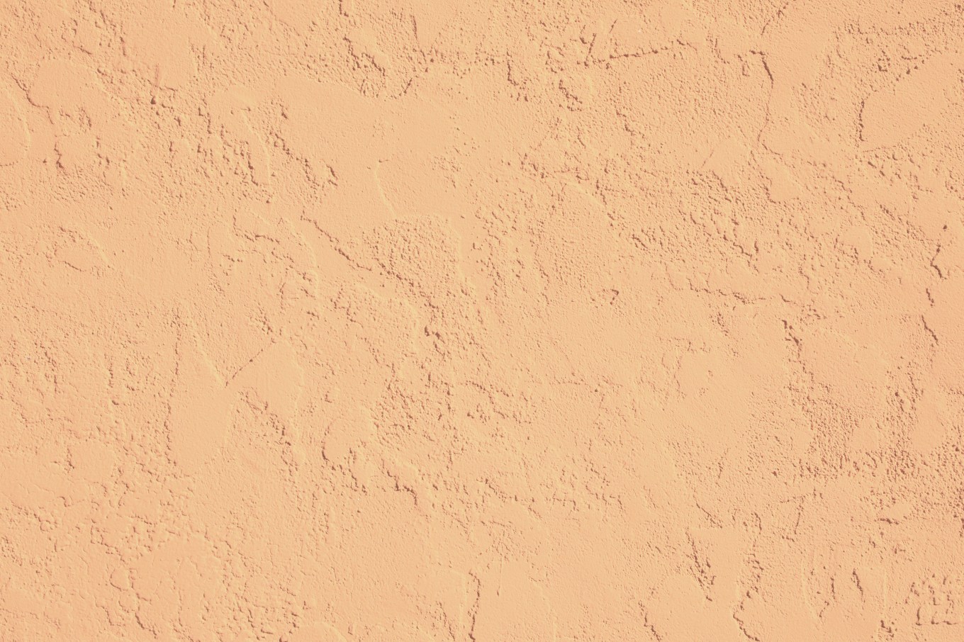 Close up of the texture of stucco siding on a house.