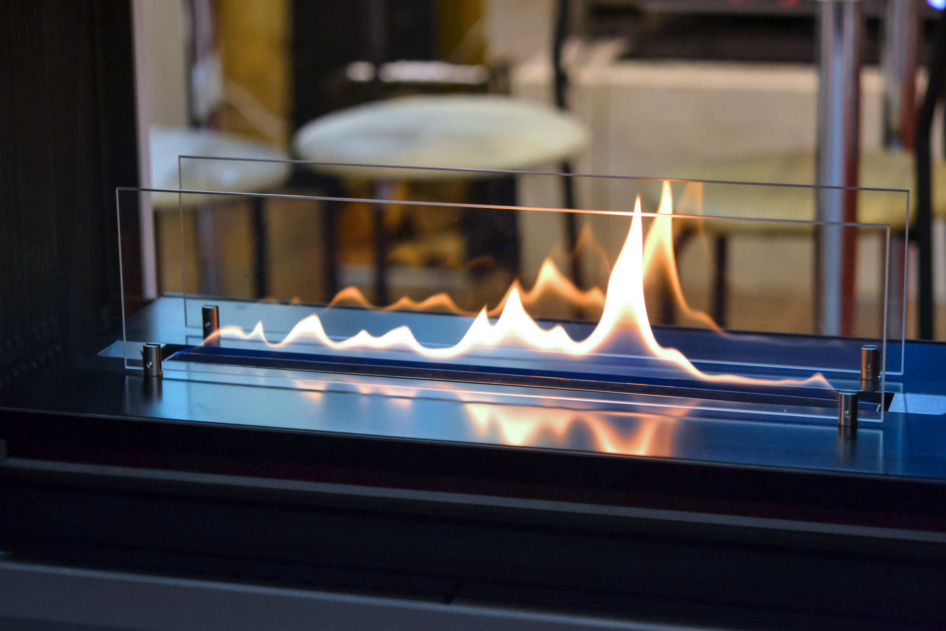 Modern ventless ethanol fireplace in a dining room.