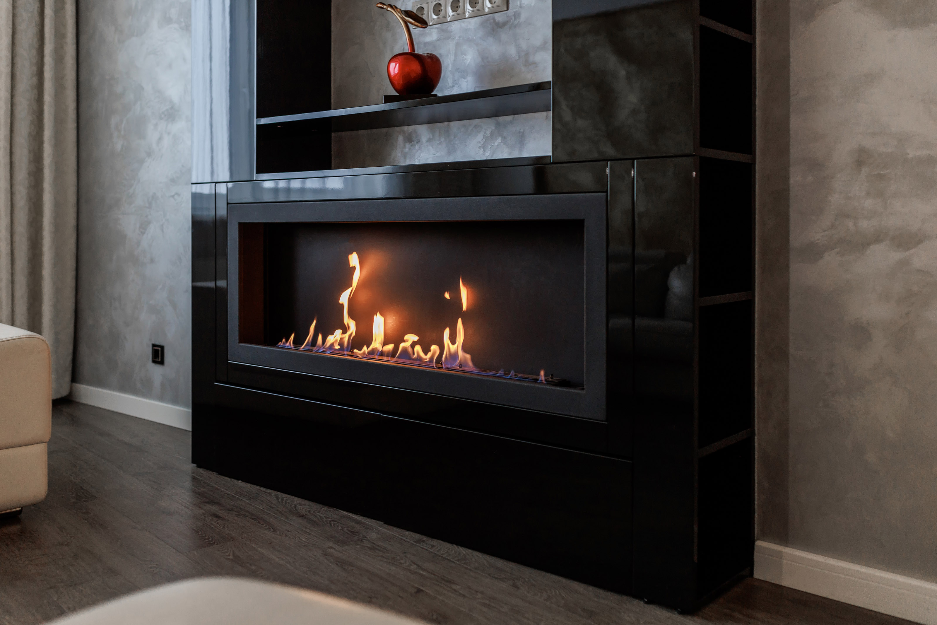 Contemporary mount ventless ethanol fireplace fireplace. Modern smart ecological alternative technologies. Interior design of a house inside.