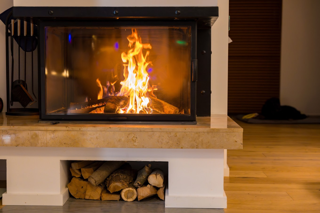 A warm and cozy fireplace with wood logs burning, creating a relaxing and inviting atmosphere in the home during a cold winter.