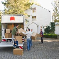 A multigenerational family unpacking boxes to move into a new home.