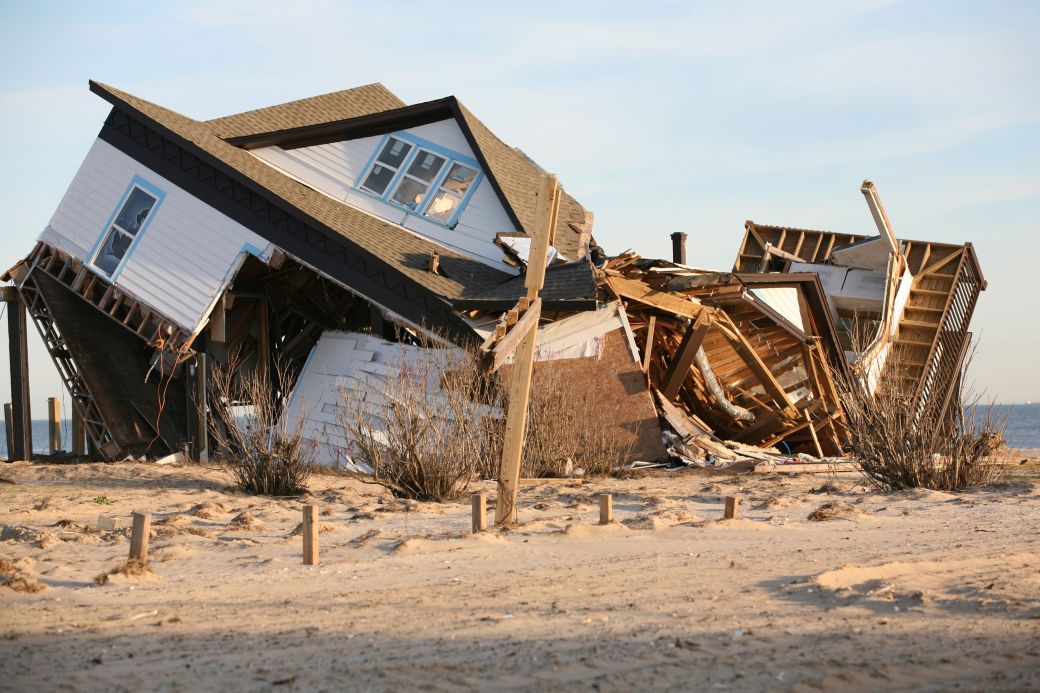 A house on the beach is destroyed by a natural disaster.