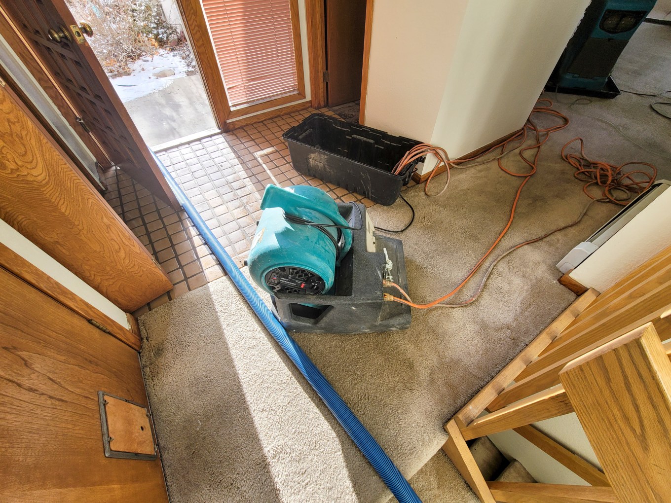 An air mover and a heater placed to dry out a home that has water damage.