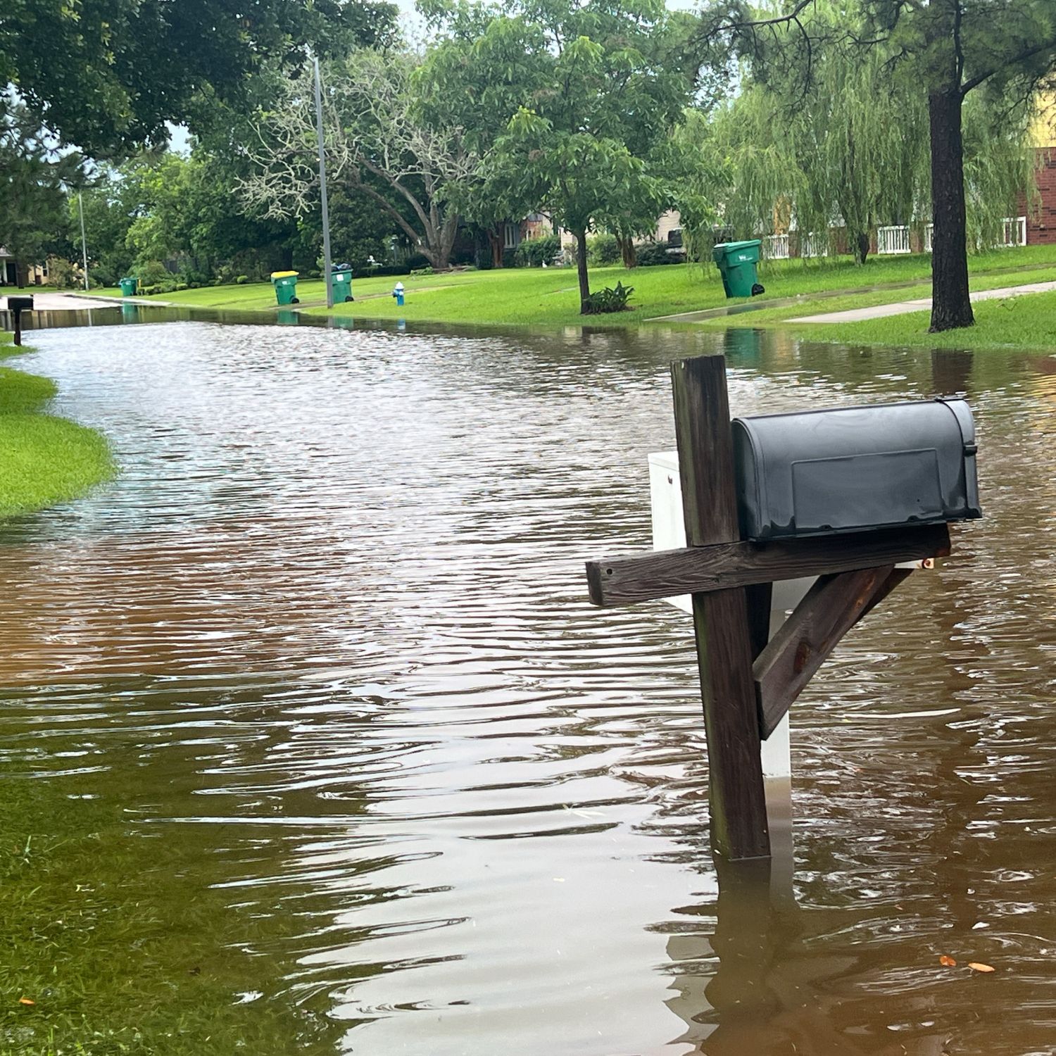 Flooding caused by rain on a suburban Texas street.