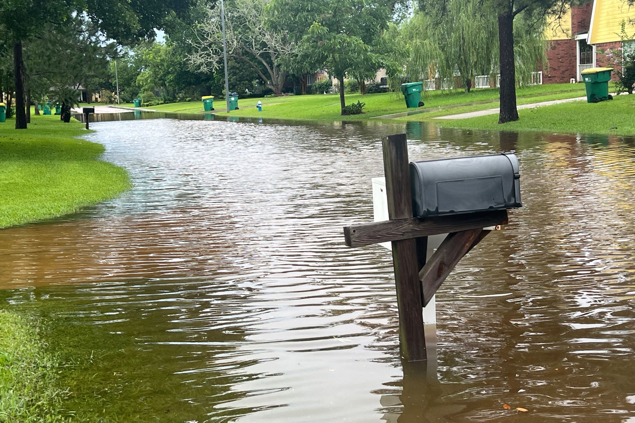 Flooding caused by rain on a suburban Texas street.