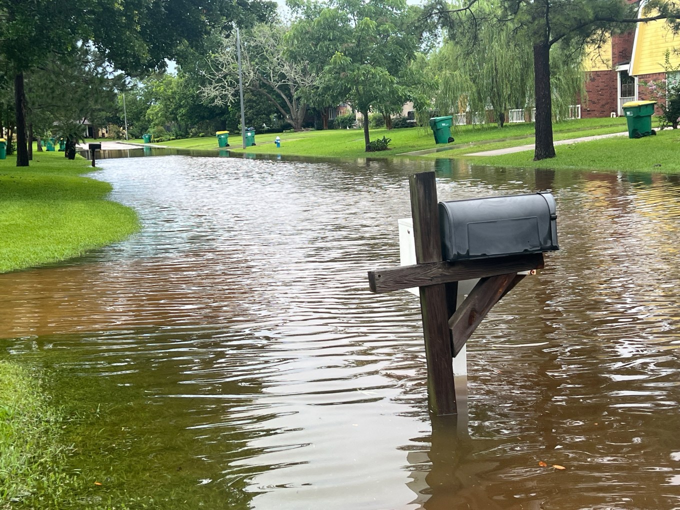 Flooding caused by rain on a suburban Texas street.