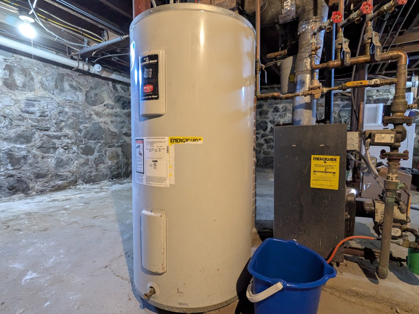 A water heater in the basement of a single family home. Routine maintenance of water heaters is an important step in maintaining your home.